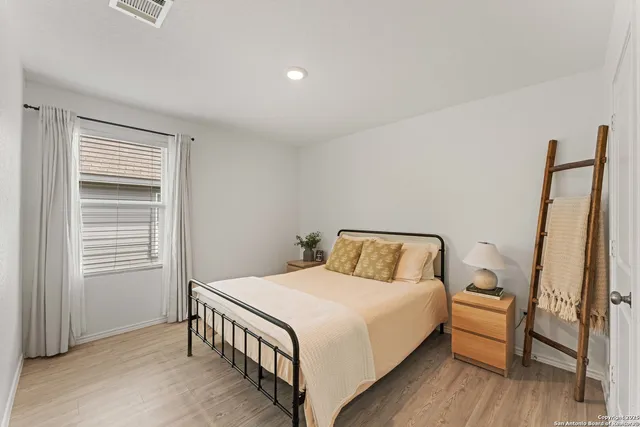 a bedroom with a bed and a window