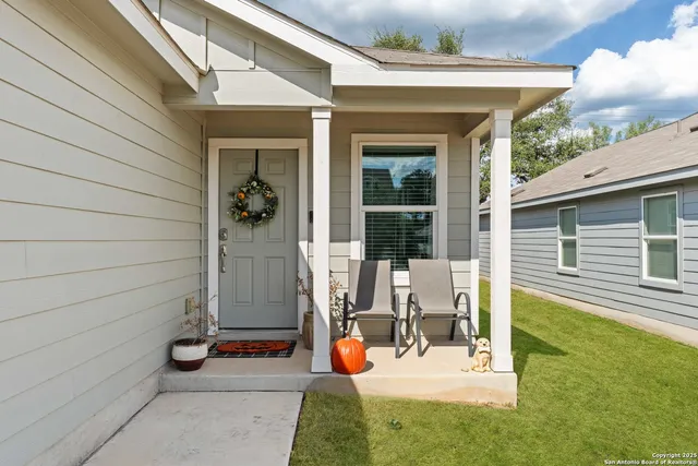 a view of house with backyard outdoor seating and hardwood