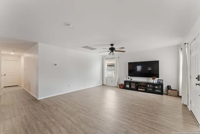 a view of a livingroom with furniture and a flat screen tv