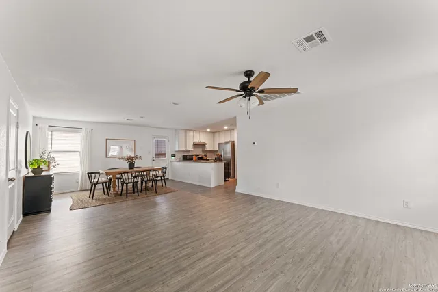 a view of living room with furniture and wooden floor