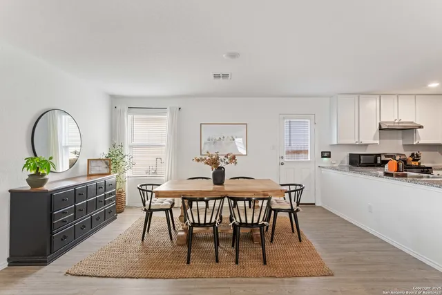 a dining room with furniture and window