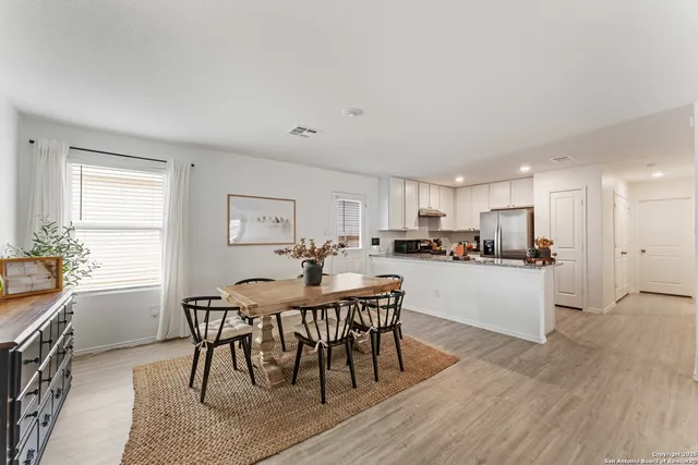 a view of a dining room with furniture and wooden floor