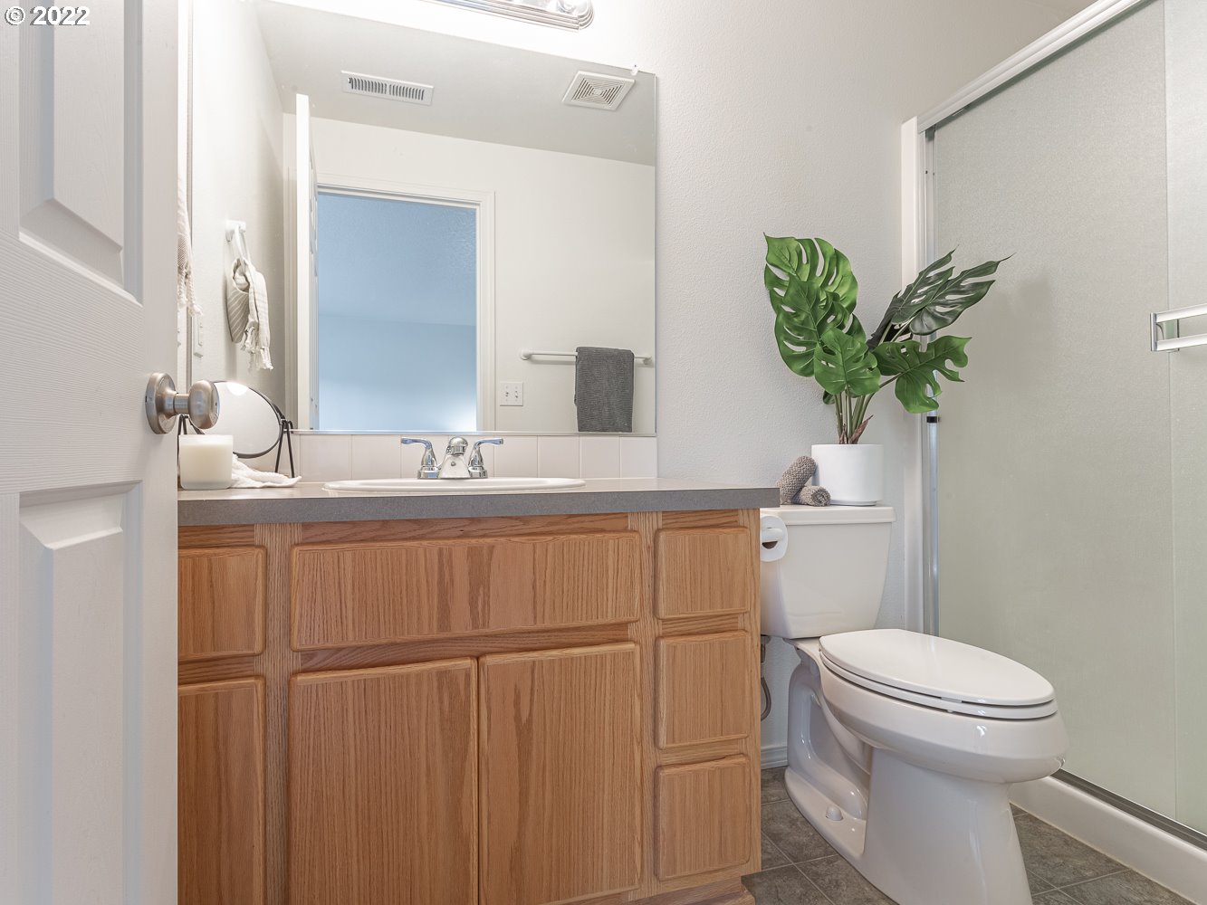 3206 South 2nd Way Ridgefield, WA 98642 - Photo 23 of 32 a bathroom with a toilet a sink and mirror