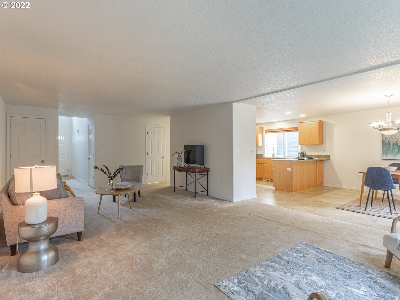 3206 South 2nd Way Ridgefield, WA 98642 - Photo 5 of 32 a living room with furniture and a dining table with kitchen view