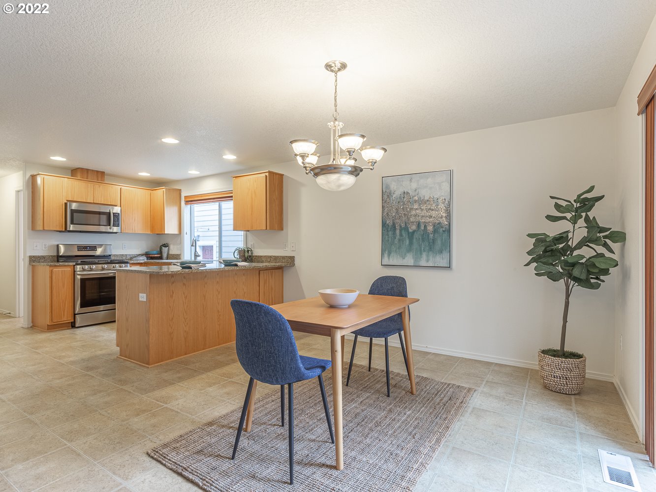 3206 South 2nd Way Ridgefield, WA 98642 - Photo 8 of 32 a dining room filled chandelier and kitchen view