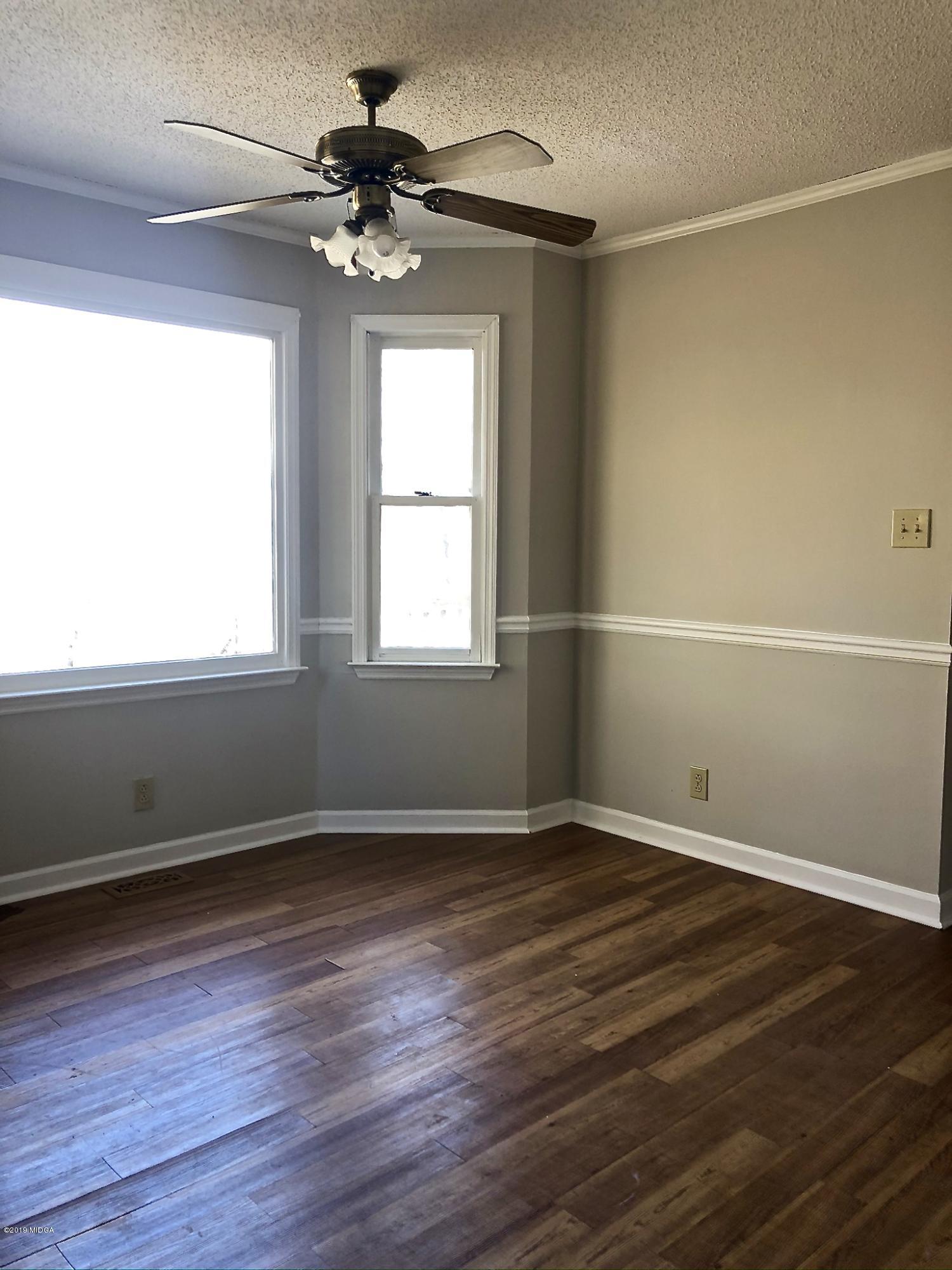 230 J R Boulevard Macon, GA 31220 - Photo 8 of 12 a view of an empty room with wooden floor and a window