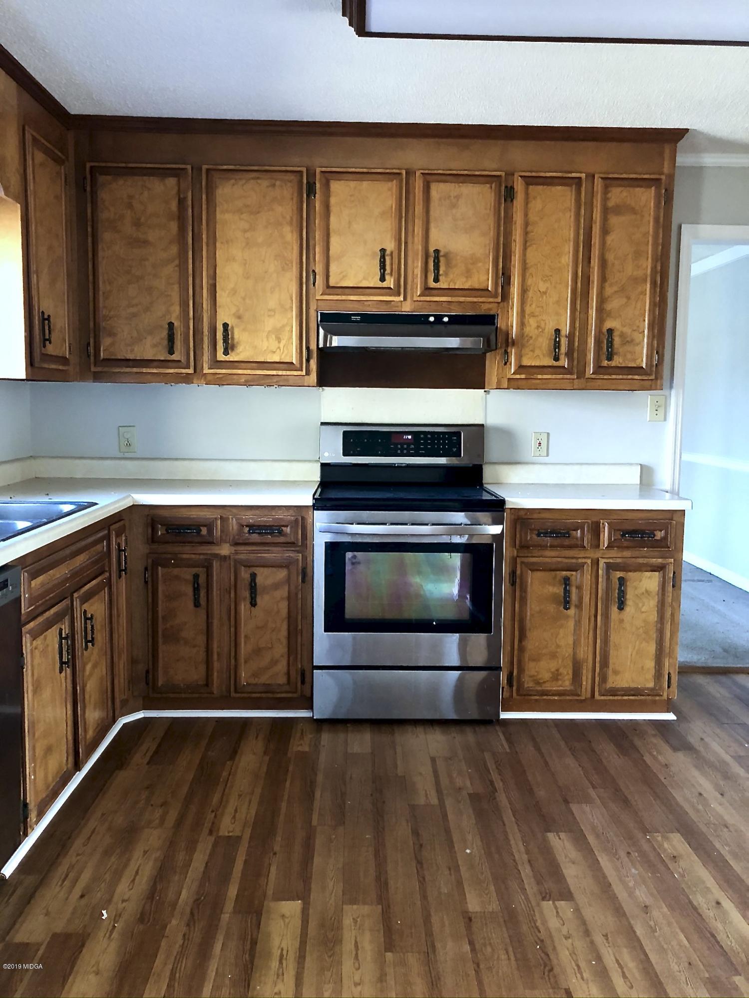 230 J R Boulevard Macon, GA 31220 - Photo 9 of 12 a kitchen with stainless steel appliances granite countertop a stove and a sink
