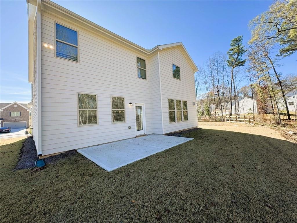2180 Highridge Point Drive Lithia Springs, GA 30122 - Photo 21 of 24 a view of a house with backyard and garden
