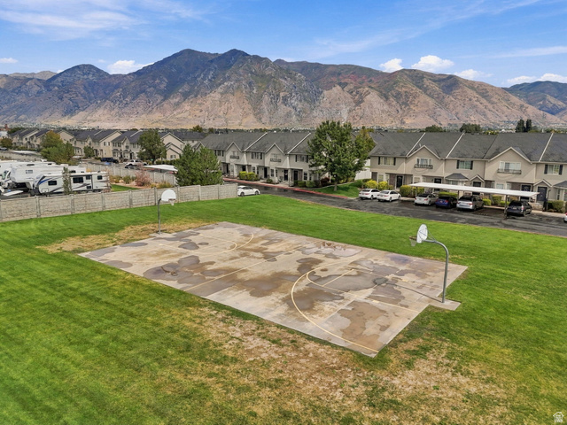 1041 South 1850th Street West Springville, UT 84663 - Photo 29 of 35 Outdoor basketball court with two hoops, surrounded by a grassy area and framed by distant mountains