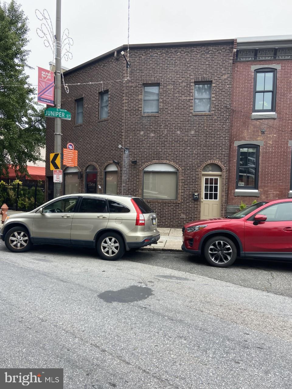 a couple of cars parked in front of a brick building
