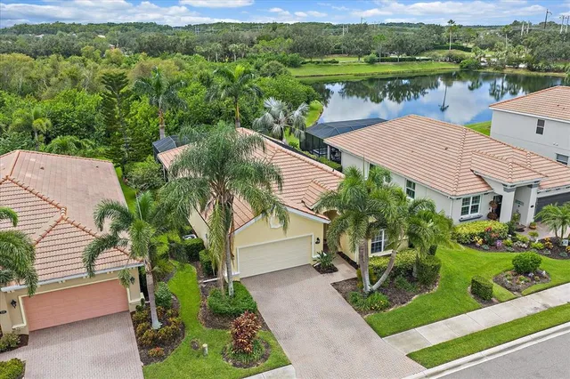 an aerial view of house with yard and lake view