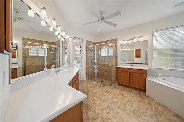a large spacious bathroom with a large tub shower and sink