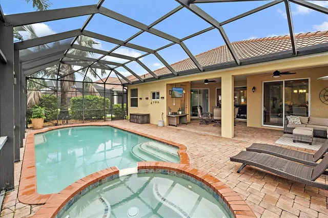 a indoor swimming pool with barbeque outdoor seating