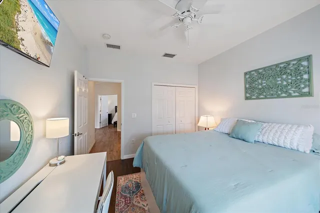 a bedroom with a bed and a mirror