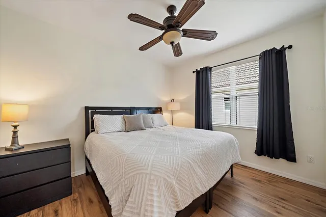 a bedroom with a bed and a night stand