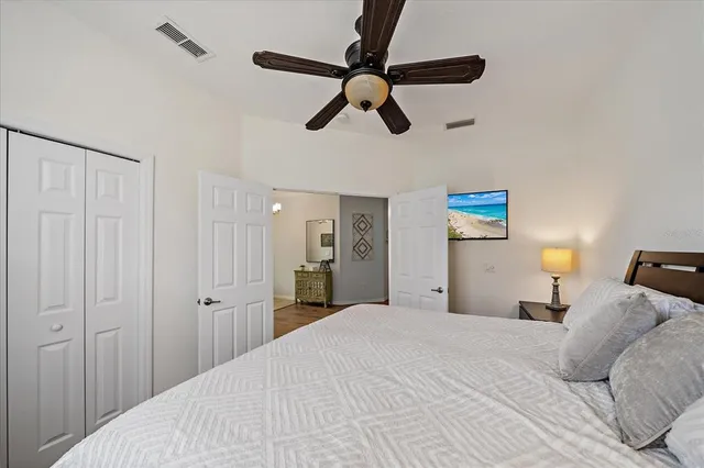 a bedroom with a bed and a chandelier