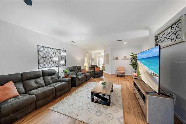a living room with furniture window and a flat screen tv