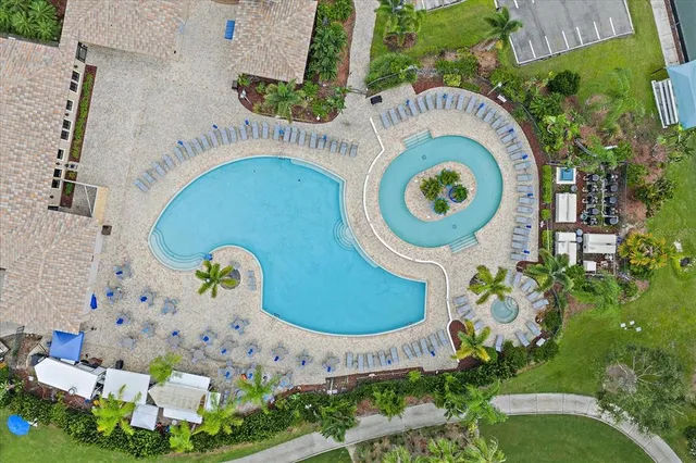 an aerial view of a house with garden space and swimming pool