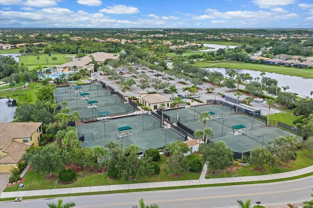 an aerial view of residential houses with outdoor space and river