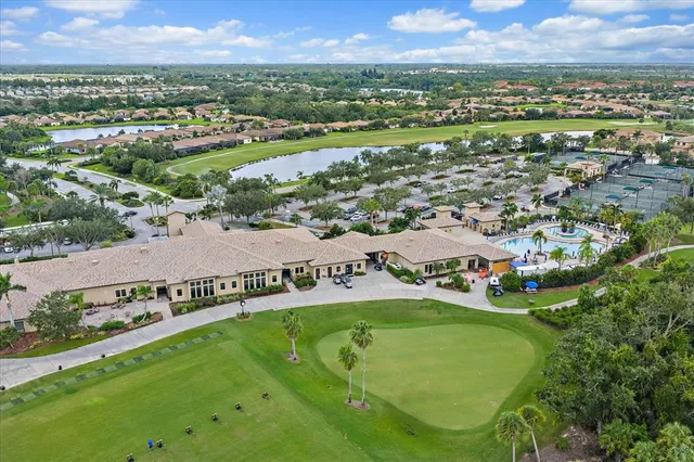 an aerial view of residential houses with outdoor space and city view