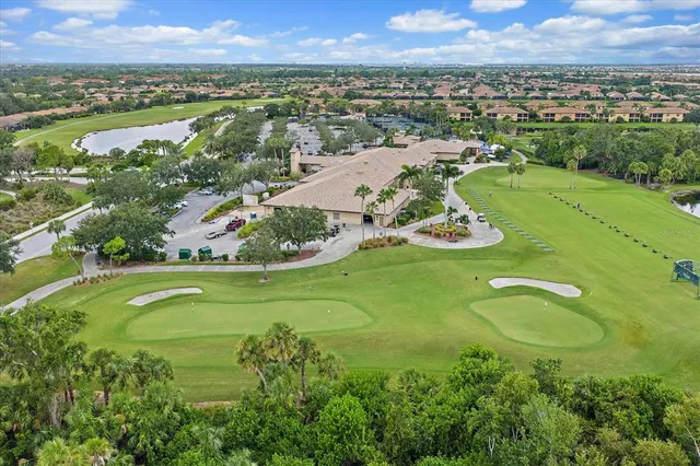 an aerial view of residential houses with outdoor space and trees