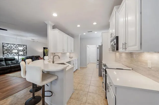 a large kitchen with a table and chairs