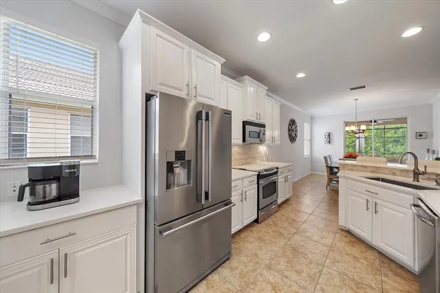 a kitchen with stainless steel appliances a refrigerator sink and microwave
