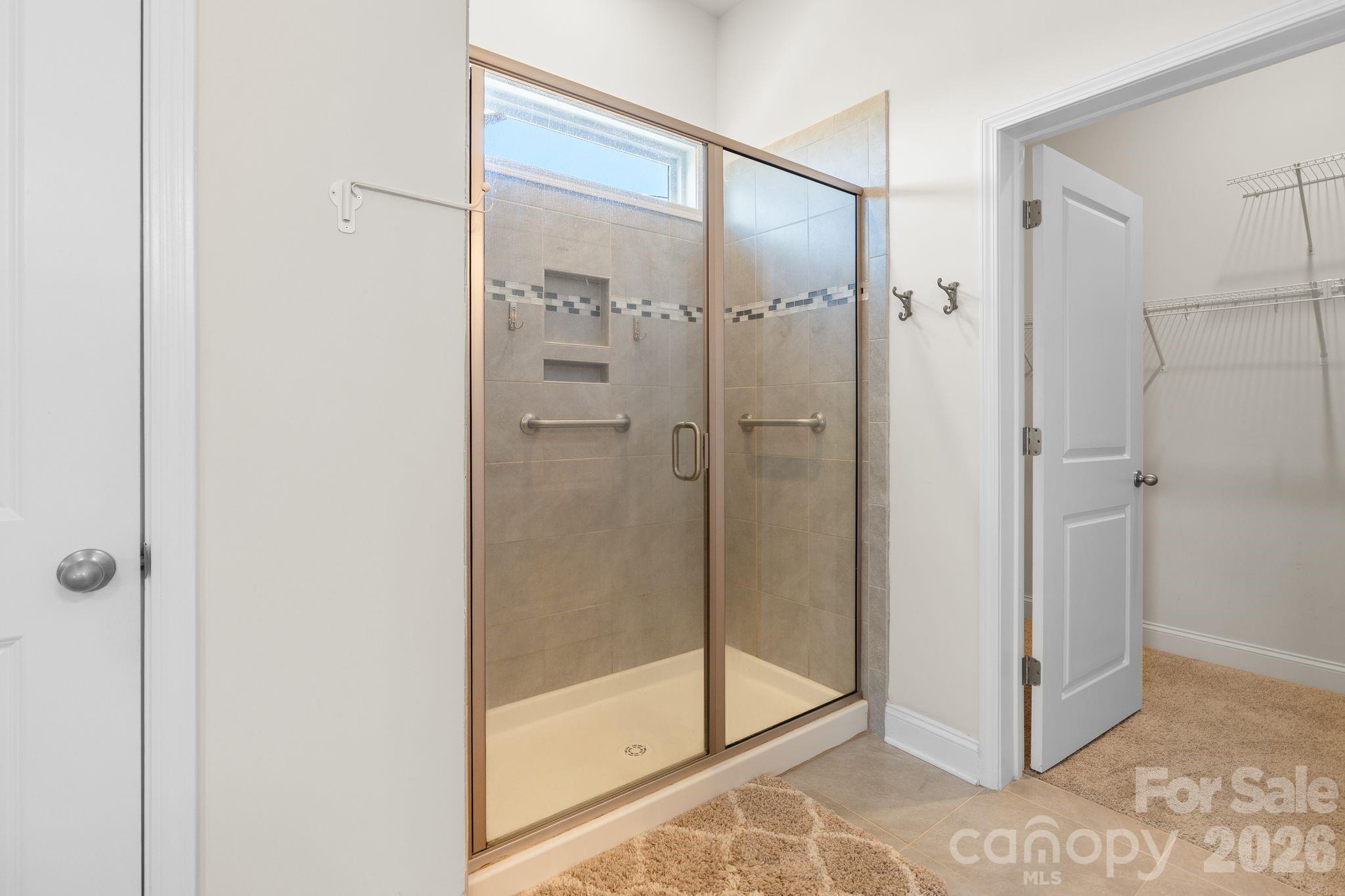 34 Rose Creek Road Leicester, NC 28748 - Photo 23 of 37 a bathroom with a glass shower door