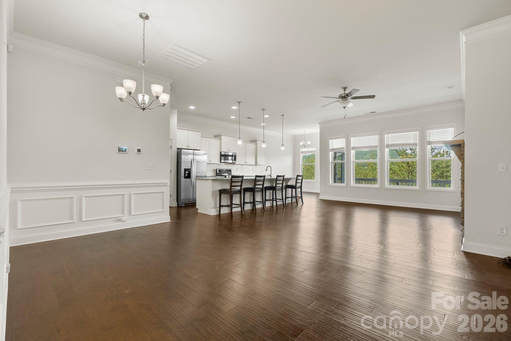 34 Rose Creek Road Leicester, NC 28748 - Photo 3 of 37 a view of a livingroom with furniture wooden floor windows and a chandelier