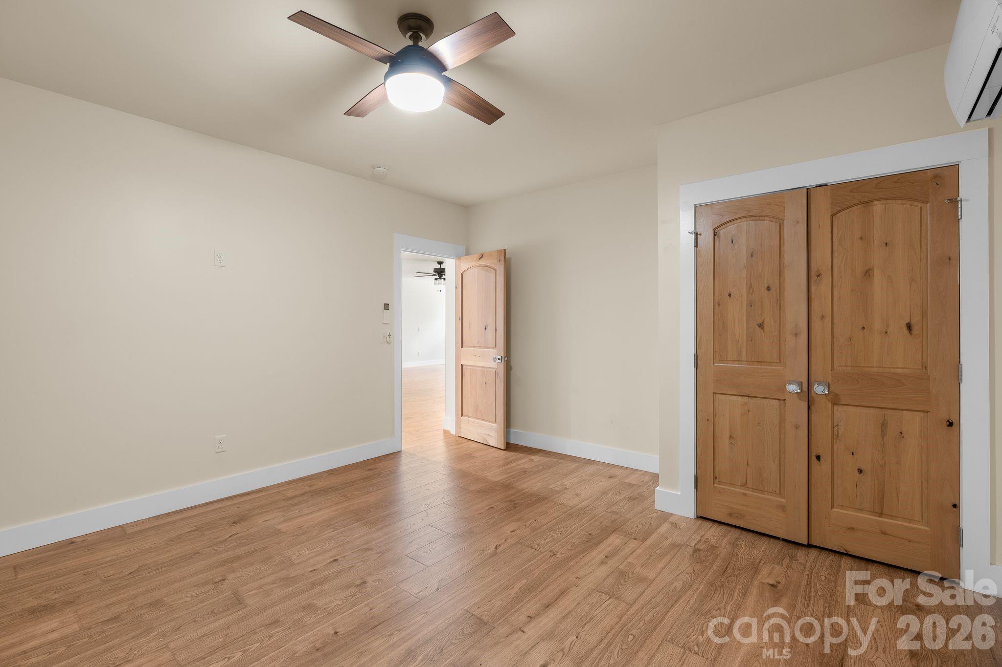 34 Rose Creek Road Leicester, NC 28748 - Photo 31 of 37 an empty room with wooden floor cabinet and windows