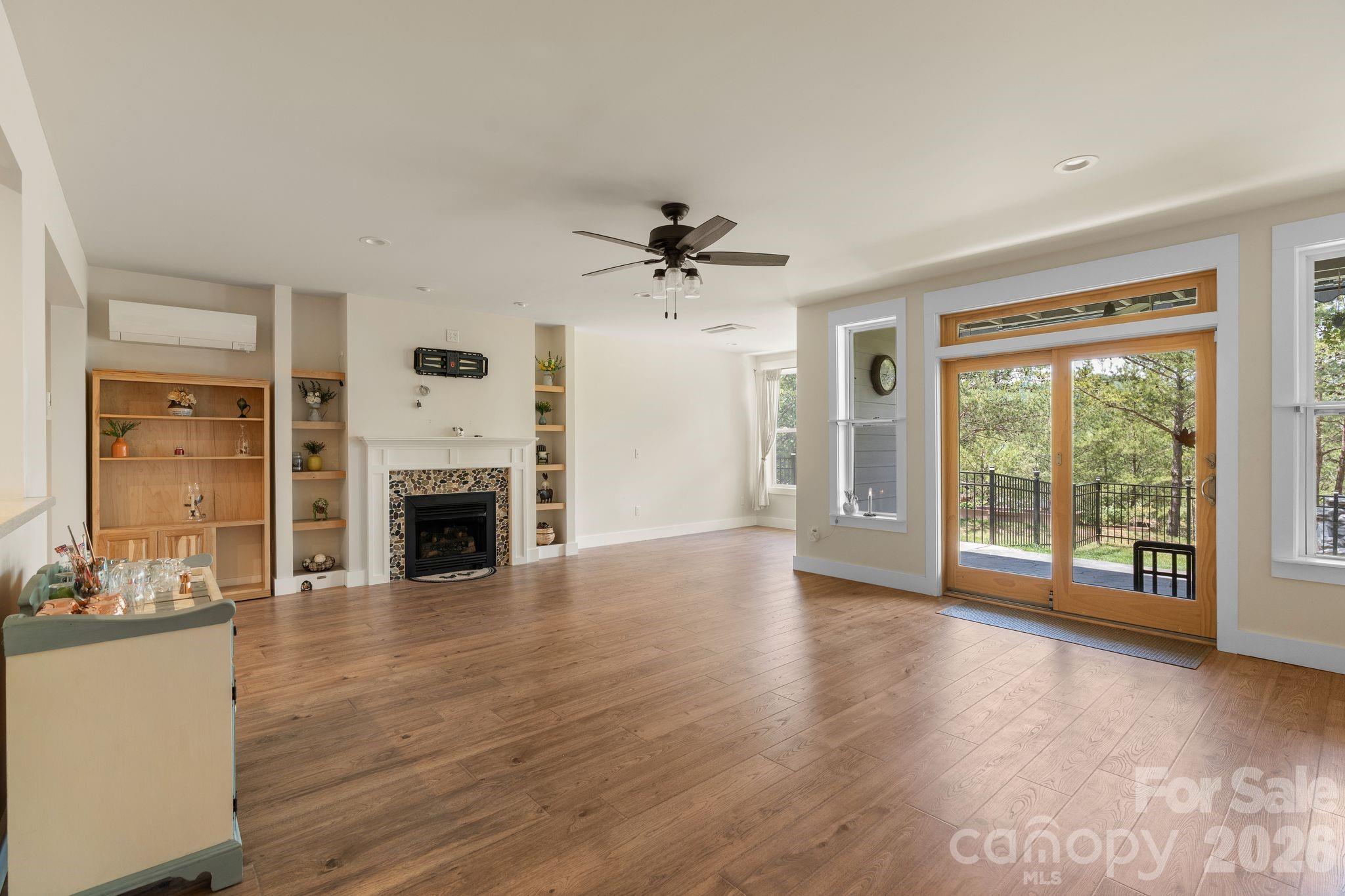 34 Rose Creek Road Leicester, NC 28748 - Photo 32 of 37 a view of an empty room with a fireplace and a window