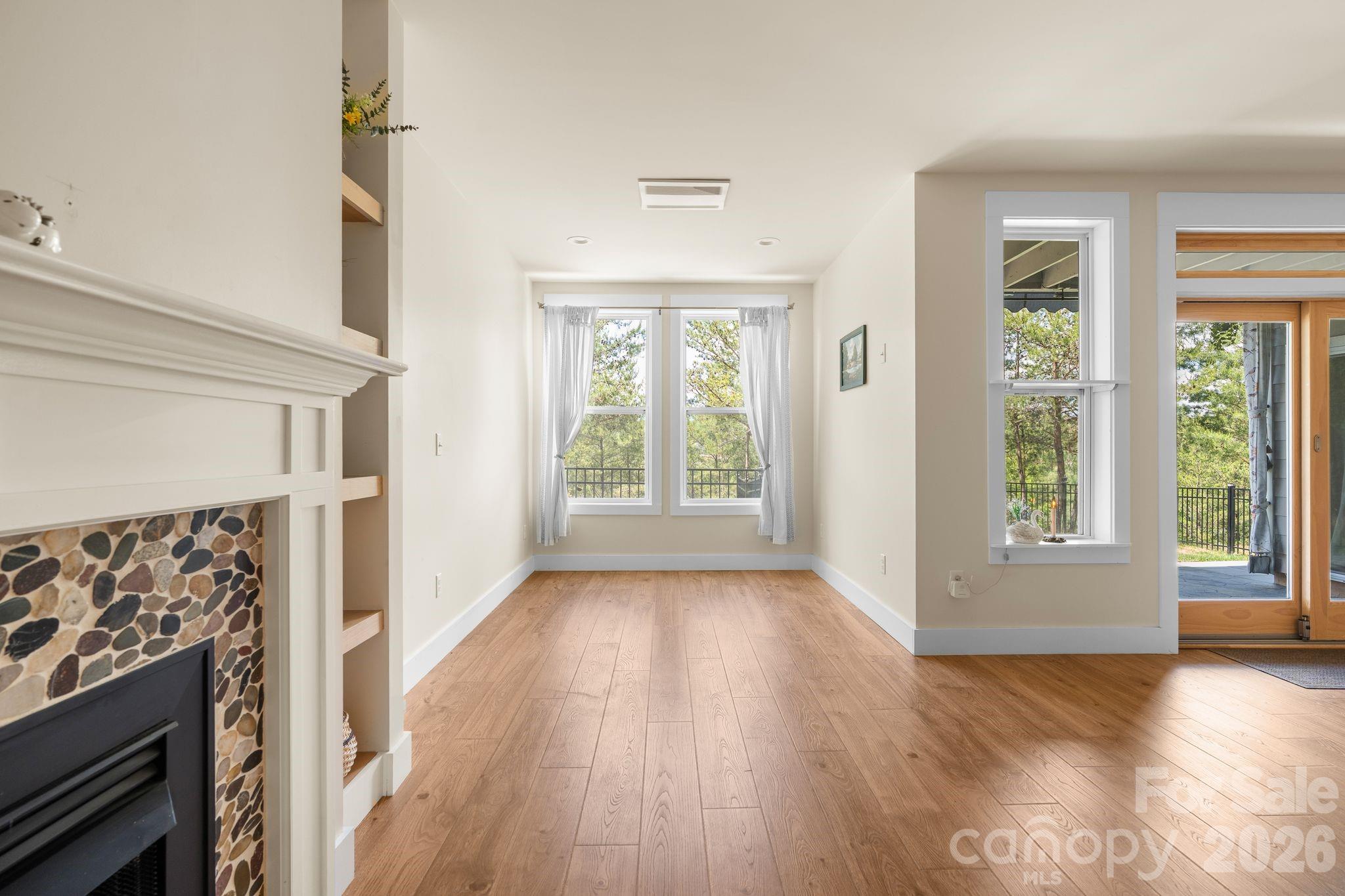 34 Rose Creek Road Leicester, NC 28748 - Photo 35 of 37 wooden floor in an empty room with a window