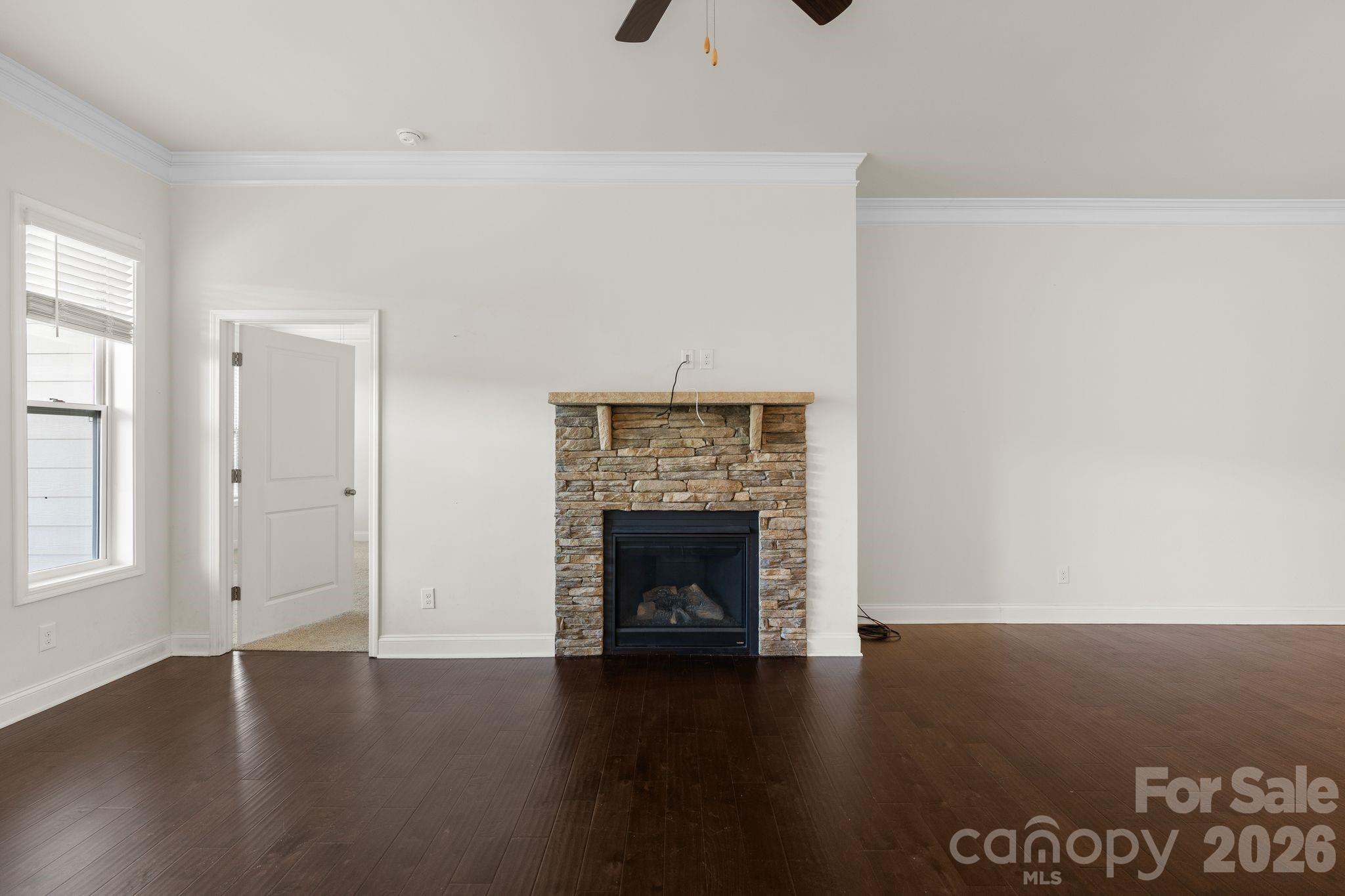 34 Rose Creek Road Leicester, NC 28748 - Photo 6 of 37 an empty room with wooden floor fireplace and windows