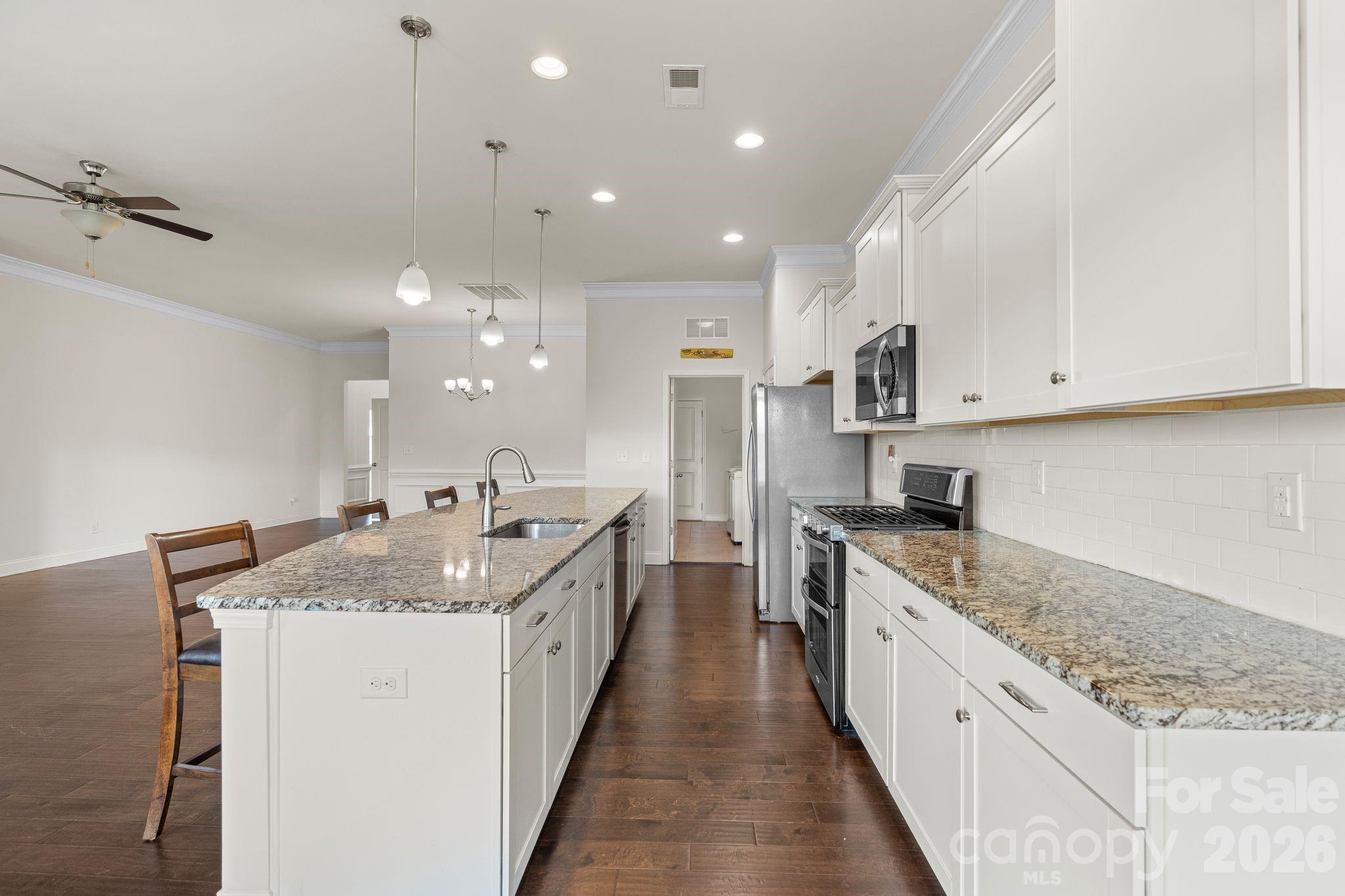 34 Rose Creek Road Leicester, NC 28748 - Photo 8 of 37 a kitchen with stainless steel appliances granite countertop a sink stove and cabinets
