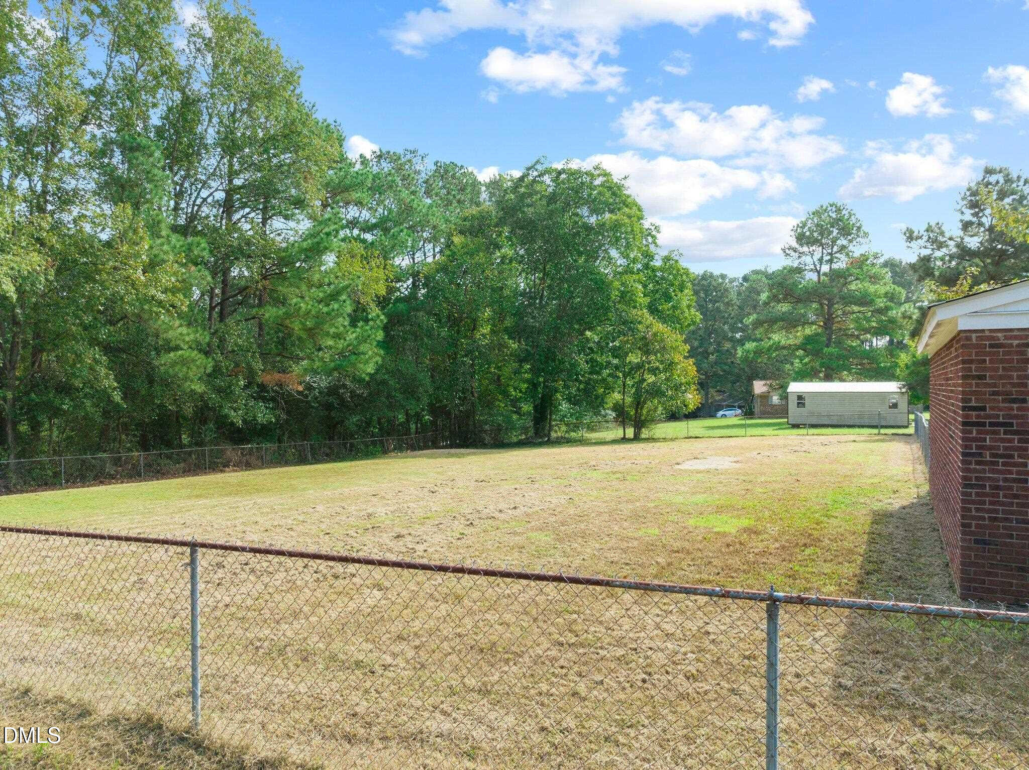 6501 Rock Service Station Road Raleigh, NC 27603 - Photo 11 of 49 a view of an outdoor space and a yard