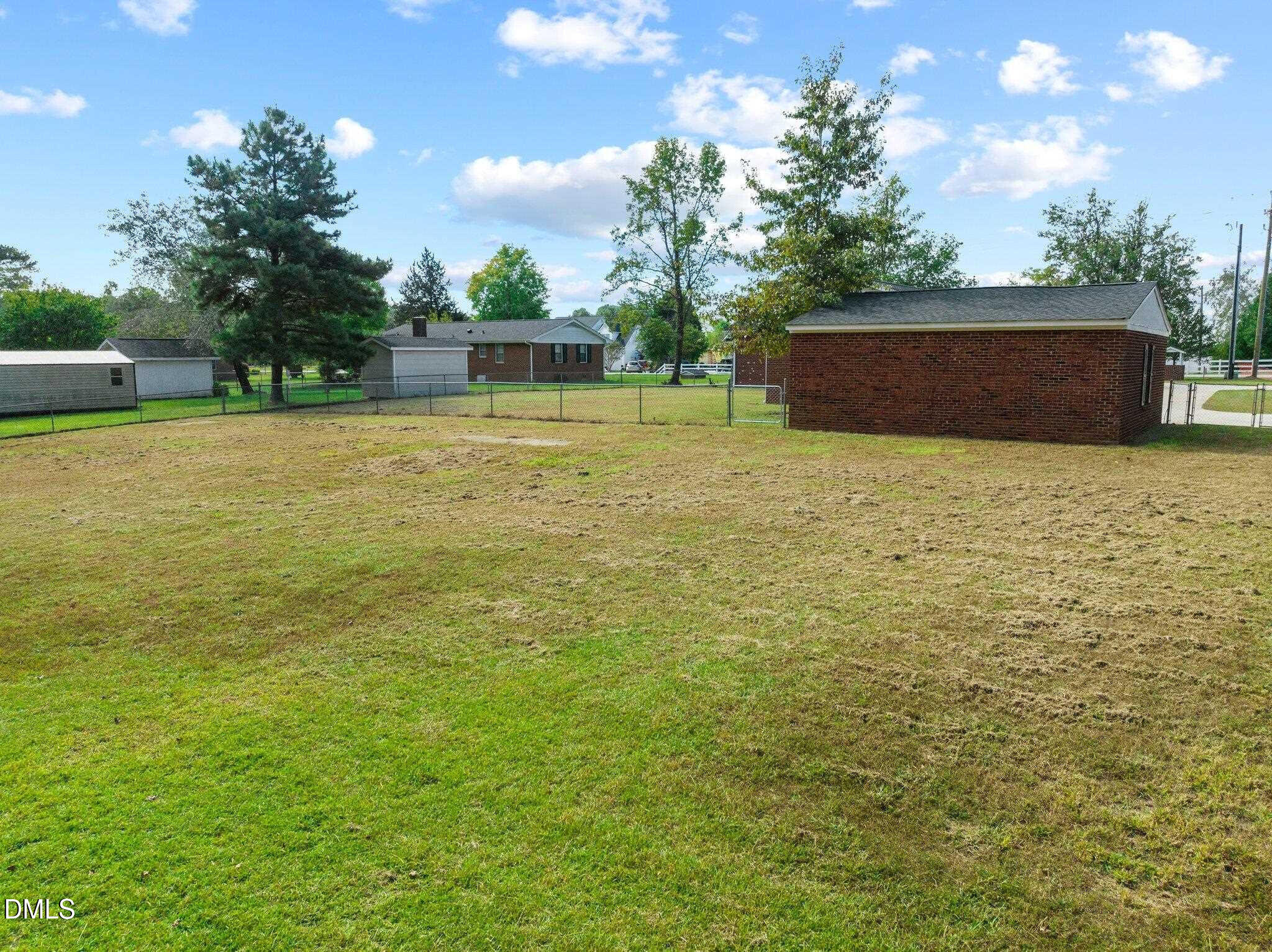 6501 Rock Service Station Road Raleigh, NC 27603 - Photo 14 of 49 a backyard of a house with lots of green space