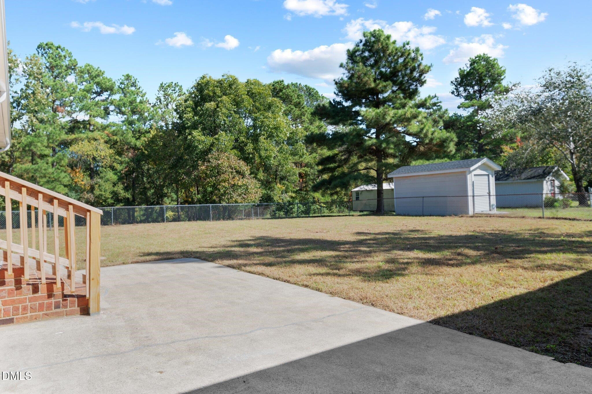 6501 Rock Service Station Road Raleigh, NC 27603 - Photo 16 of 49 a view of house with backyard and tree