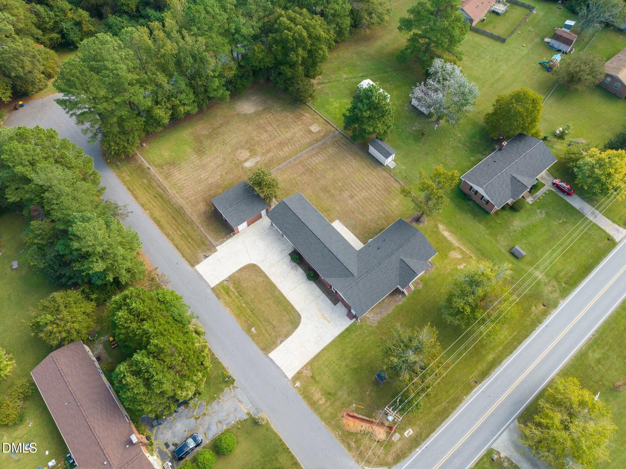 6501 Rock Service Station Road Raleigh, NC 27603 - Photo 20 of 49 an aerial view of a house with a garden and swimming pool