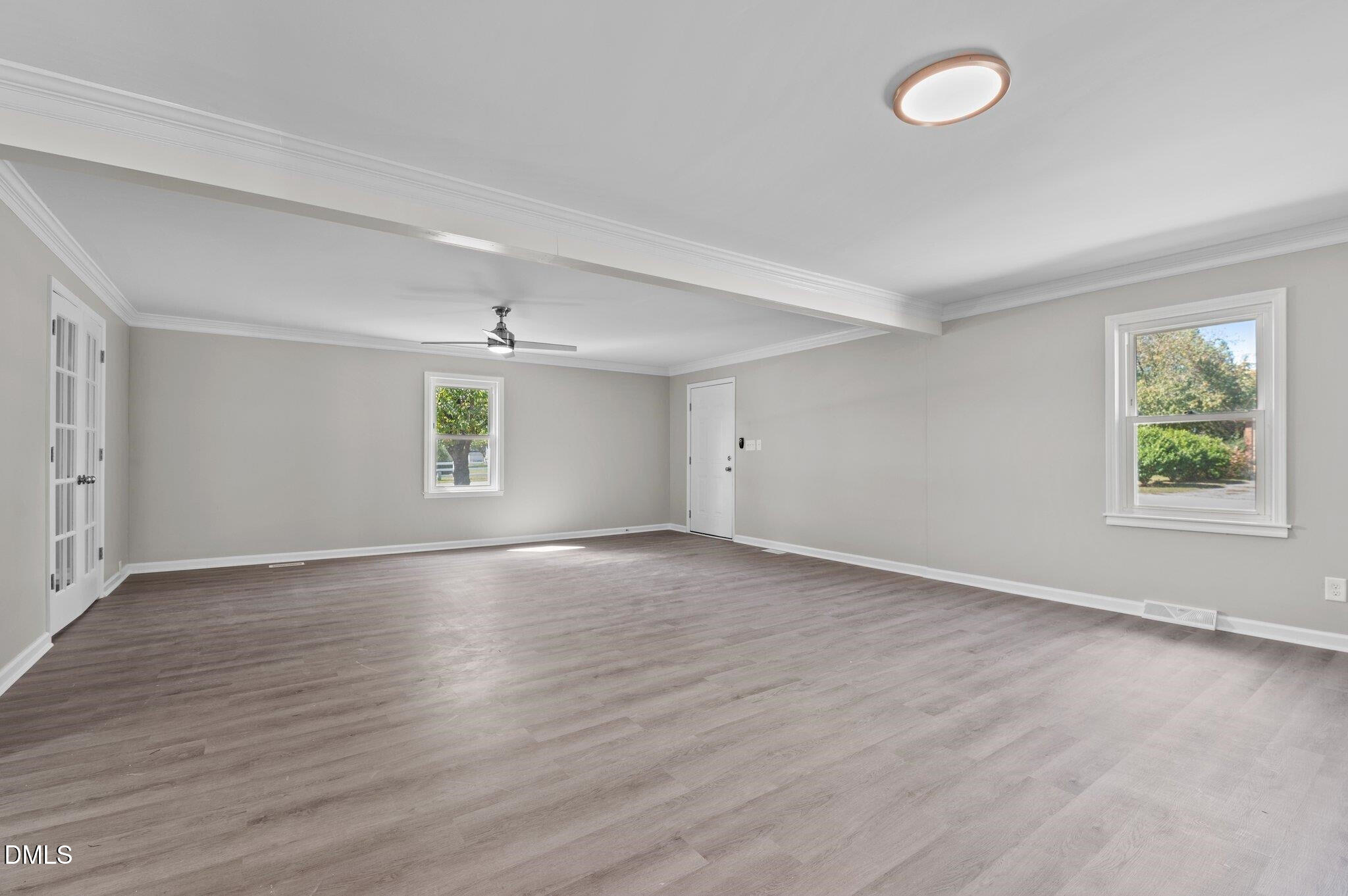 6501 Rock Service Station Road Raleigh, NC 27603 - Photo 25 of 49 an empty room with wooden floor and windows