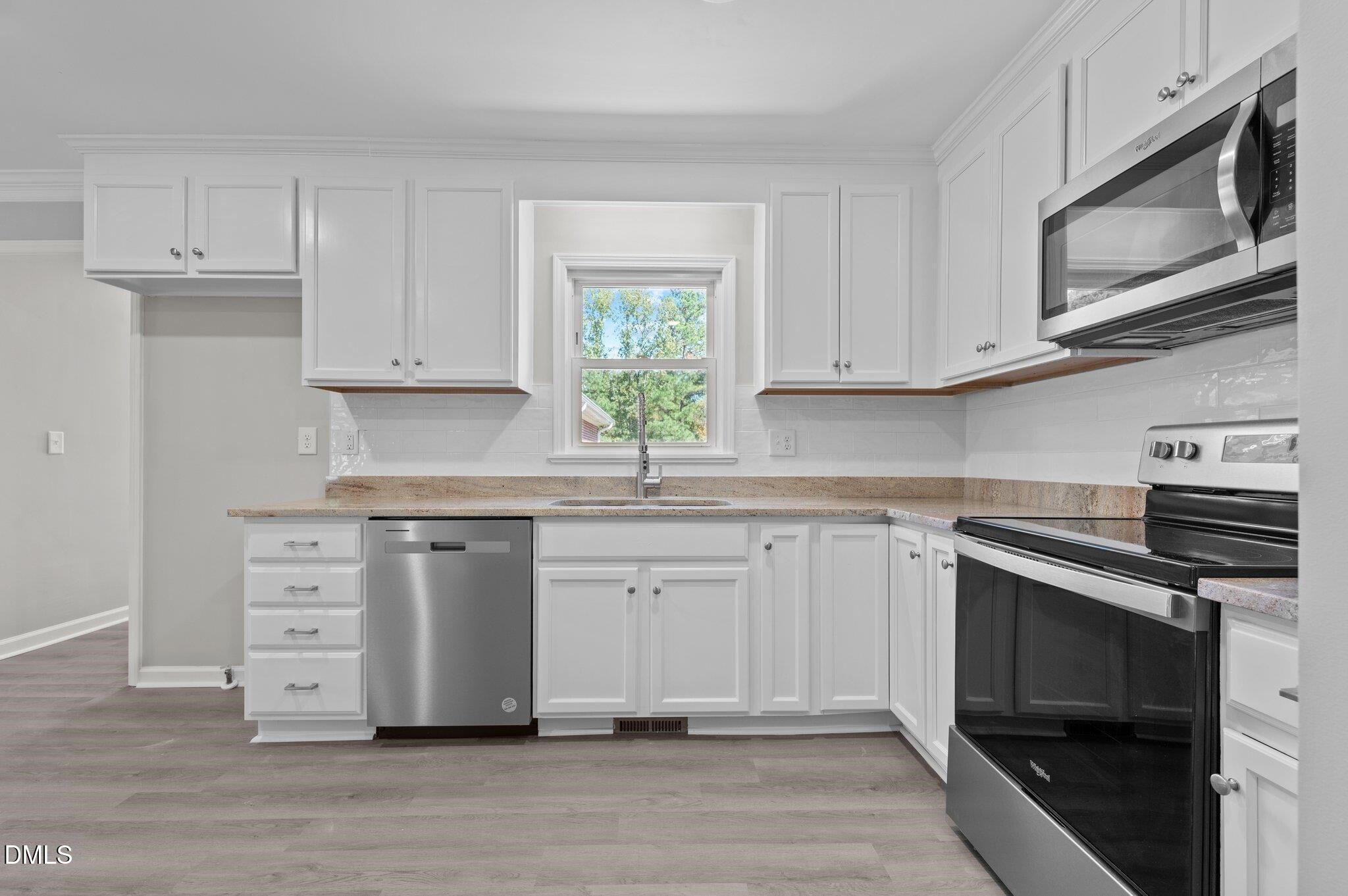 6501 Rock Service Station Road Raleigh, NC 27603 - Photo 29 of 49 a kitchen with stainless steel appliances granite countertop a stove microwave and cabinets