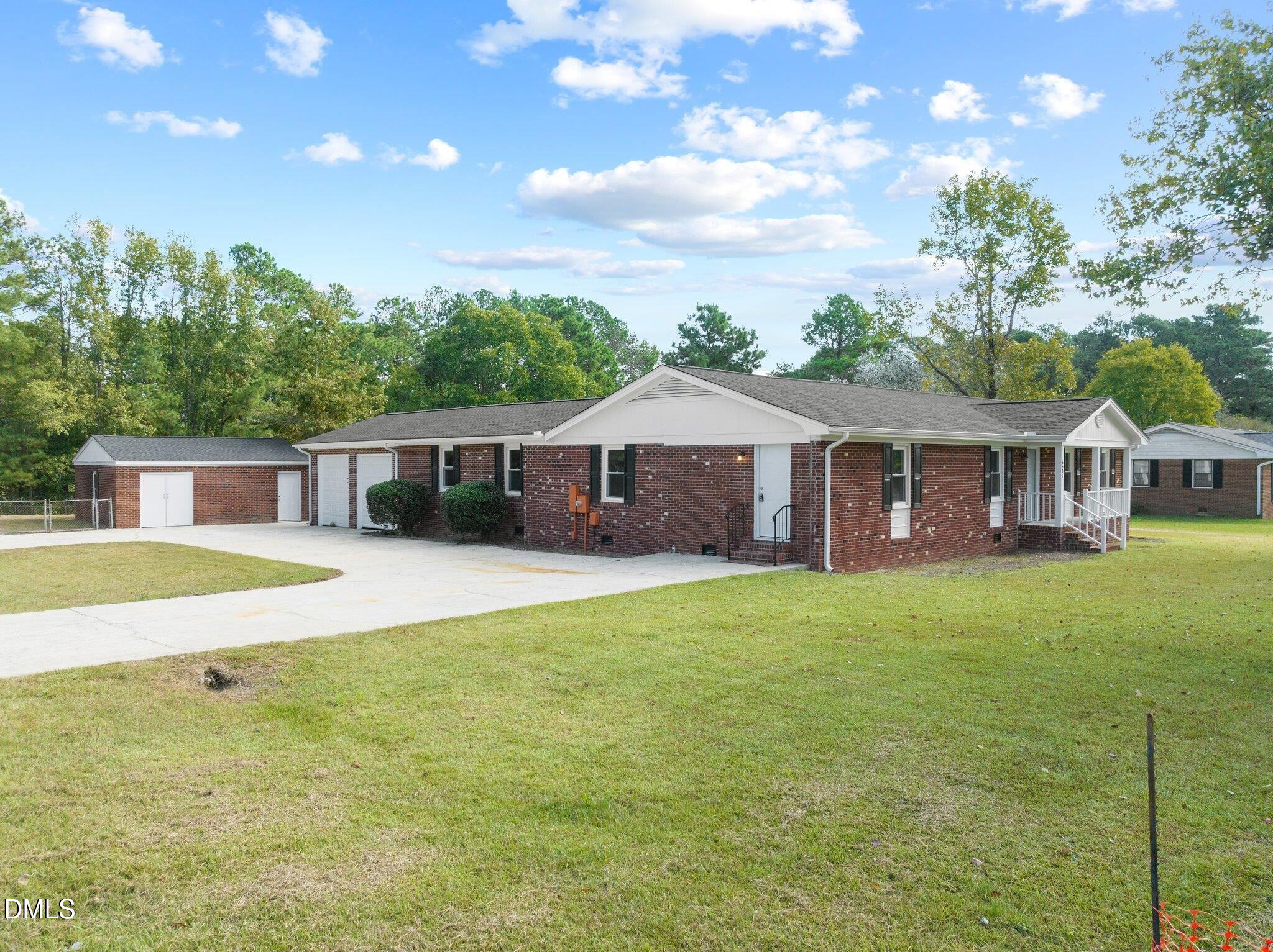 6501 Rock Service Station Road Raleigh, NC 27603 - Photo 2 of 49 a front view of a house with a garden and porch