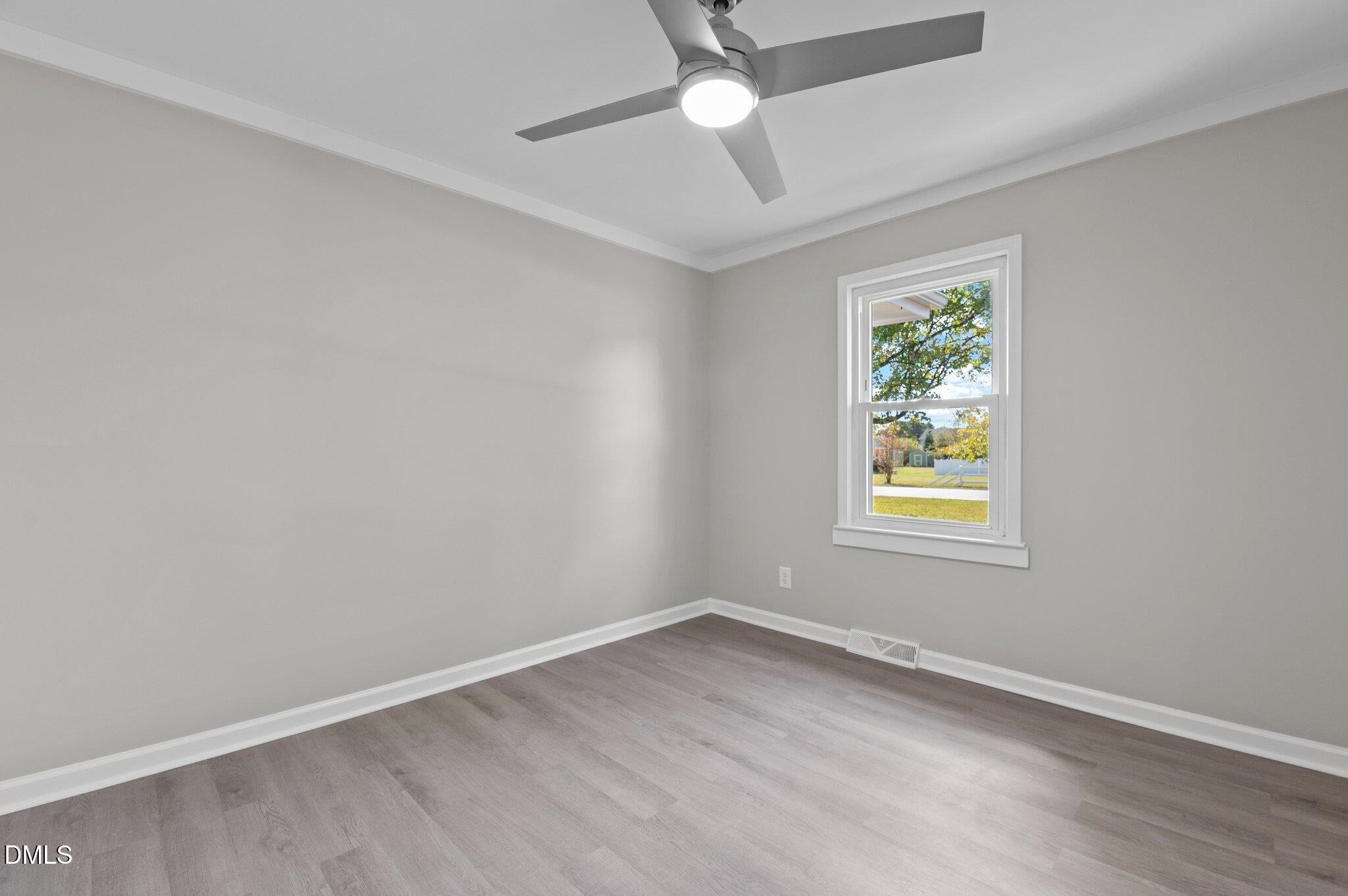 6501 Rock Service Station Road Raleigh, NC 27603 - Photo 31 of 49 an empty room with window and ceiling fan