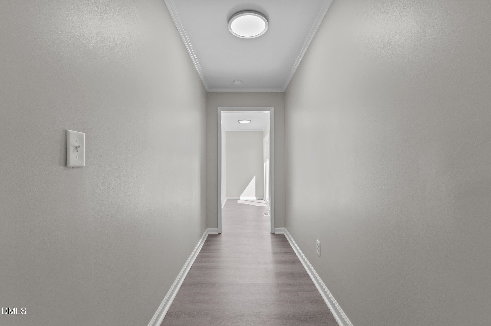 6501 Rock Service Station Road Raleigh, NC 27603 - Photo 32 of 49 a view of a hallway with wooden floor