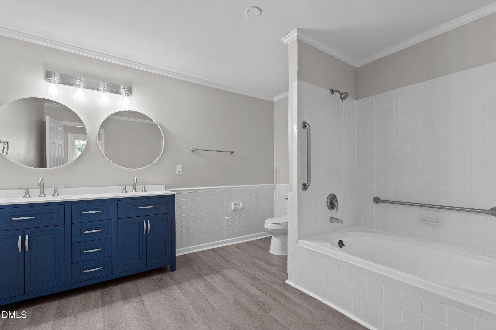 6501 Rock Service Station Road Raleigh, NC 27603 - Photo 36 of 49 a spacious bathroom with a tub sink double vanity and mirror