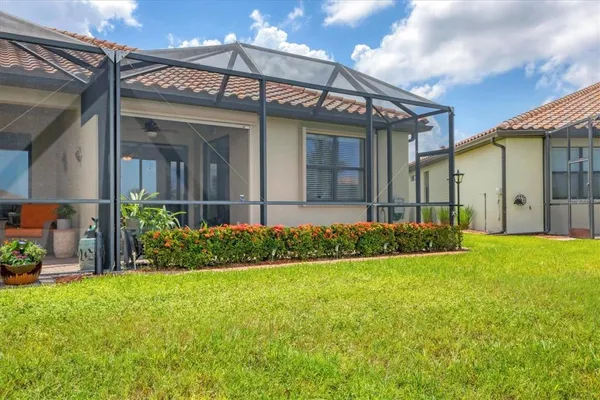 a view of a house with pool and a yard