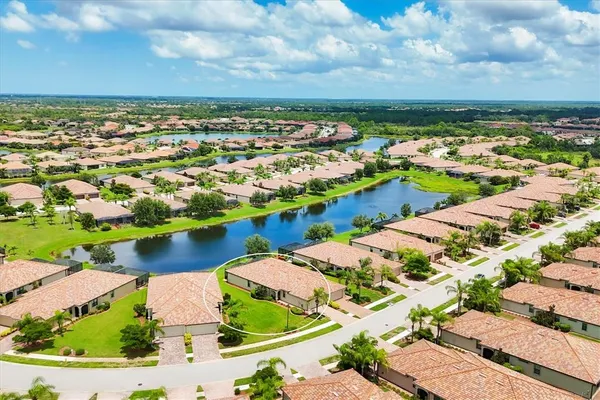 an aerial view of residential houses with yard