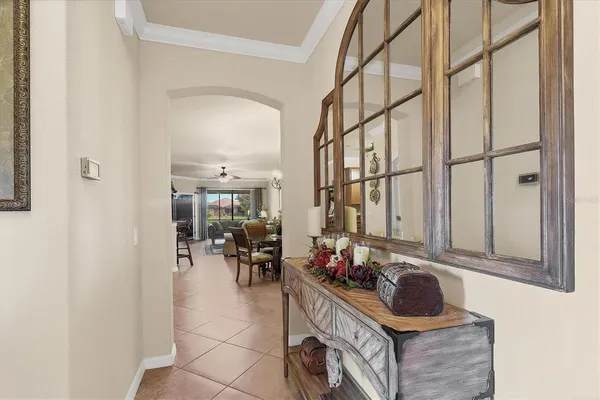 a living room with furniture a flat screen tv and a window