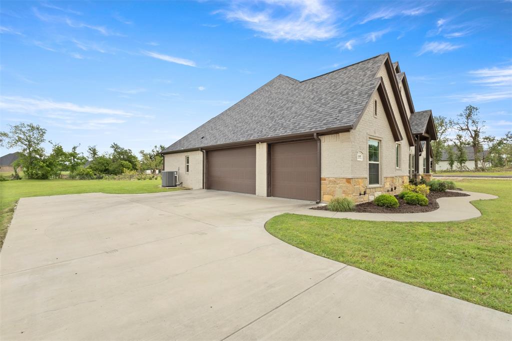 105 Clayton Crossing Springtown, TX 76082 - Photo 27 of 40 a view of a house with backyard and trees
