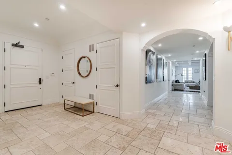 a view of a room with wooden floor and furniture