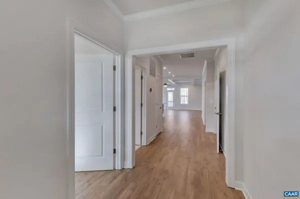 a view of a hallway with wooden floor